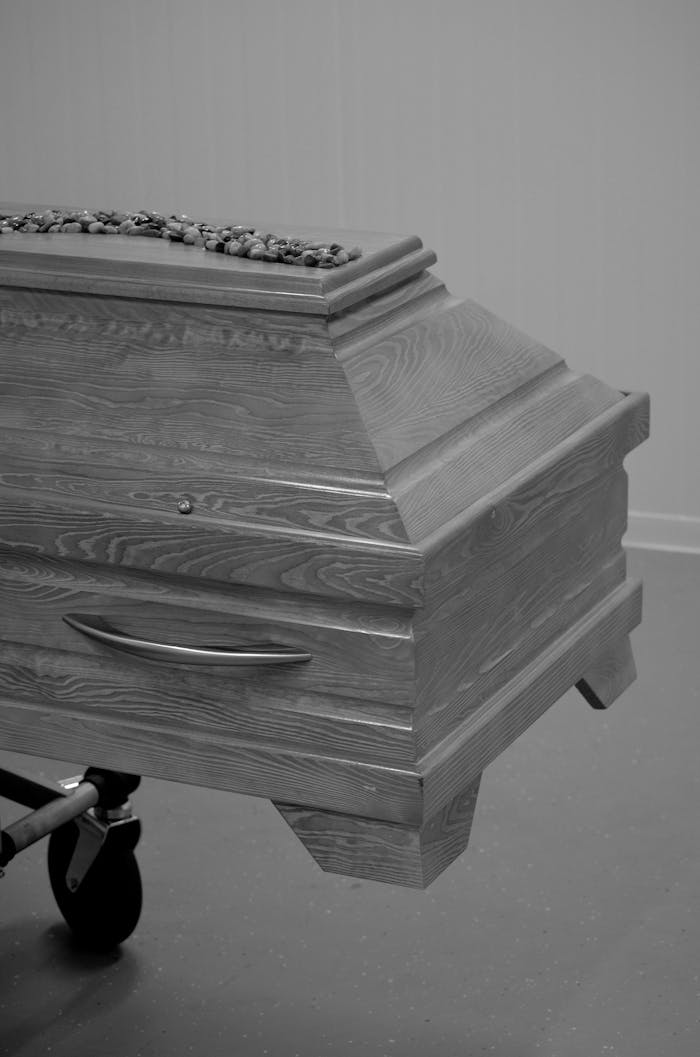 Monochrome image of a wooden coffin on a trolley in Bocholt, NRW, Deutschland.